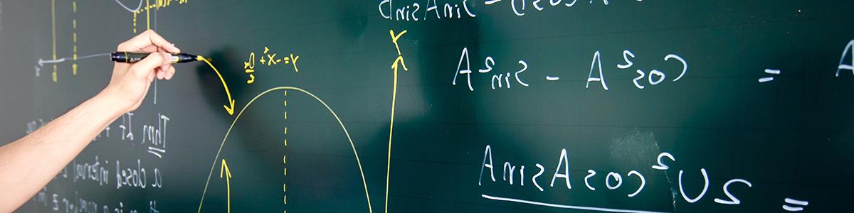 Stock photo of someone solving a math equation on a board