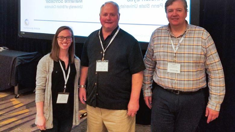 Penn State TLT Operations Team Award winners standing in front of a screen 