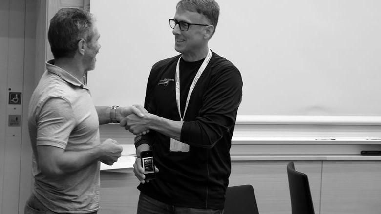 Peter Hopsicker (left) is congratulated by Dr. Alun Hardman, presdient of the IAPS