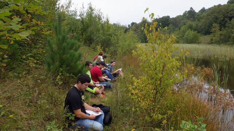 Students write while taking sights of nature