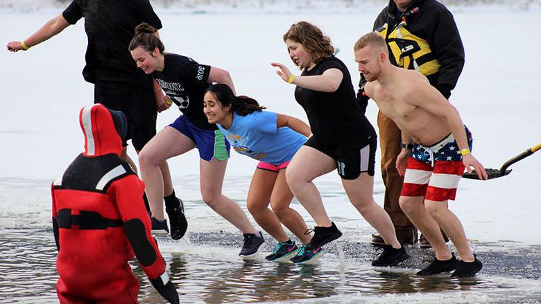 Students jump into icy water to raise funds for the annual Winter Plunge